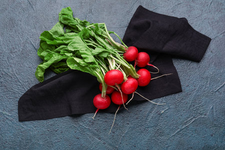 Fresh radishes with leaves on dark backgroundの写真素材