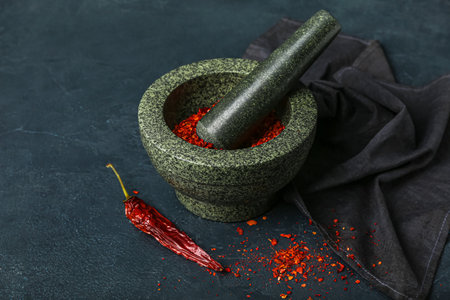 Mortar and pestle with spices on dark backgroundの写真素材