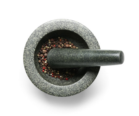 Mortar and pestle with peppercorns isolated on white backgroundの写真素材