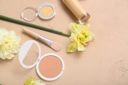Beautiful daffodils with different cosmetics on beige backgroundの写真素材