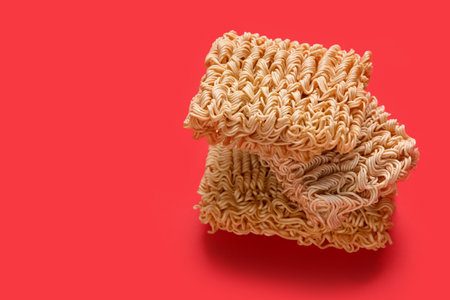 Raw instant noodles on red backgroundの写真素材