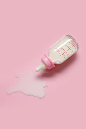 Bottle of milk for baby on pale pink backgroundの写真素材