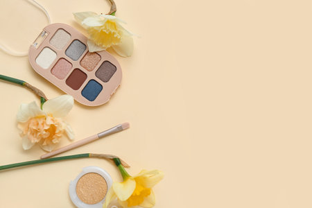 Beautiful daffodils with different cosmetics on pale yellow backgroundの写真素材