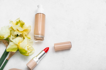 Beautiful daffodils with different cosmetics on white backgroundの写真素材