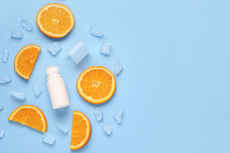 Deodorant with orange slices and ice on blue backgroundの写真素材