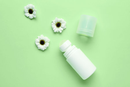 Deodorant with flowers on light green background