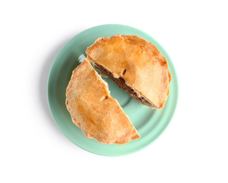 Plate with cut meat pot pie on white background