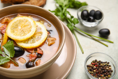 Bowl of tasty Hodgepodge soup on light background, closeupの写真素材