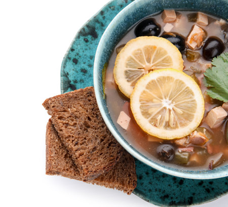 Bowl of tasty Hodgepodge soup with bread on white background, closeupの写真素材