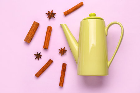 Ceramic teapot with spices on lilac backgroundの写真素材
