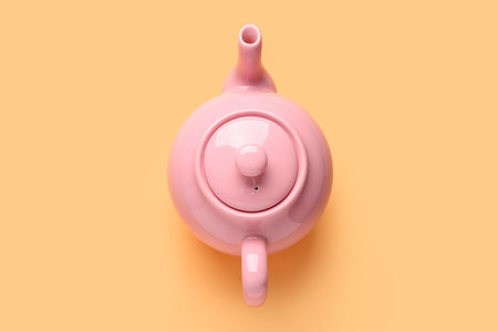 Ceramic teapot on orange backgroundの写真素材
