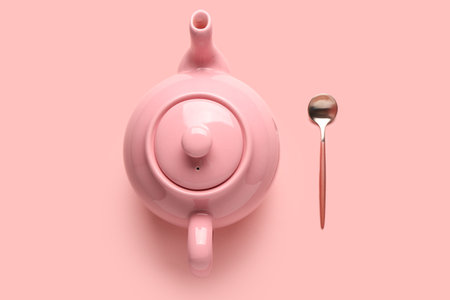 Cute ceramic teapot on pink backgroundの写真素材