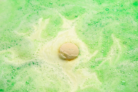 Bath bomb dissolving in waterの写真素材