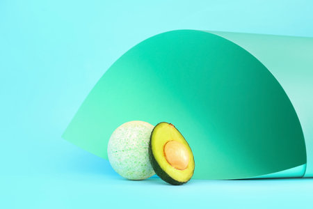 Bath bomb with avocado on paper turquoise backgroundの写真素材