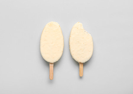 Tasty chocolate covered ice cream on light backgroundの写真素材