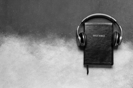 Holy Bible with headphones on grunge backgroundの写真素材