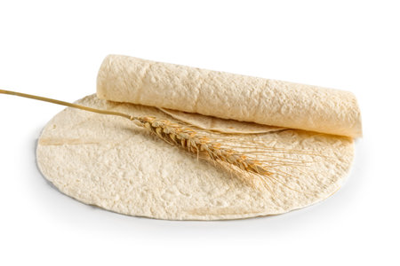 Thin lavash and wheat spikelet on white backgroundの写真素材