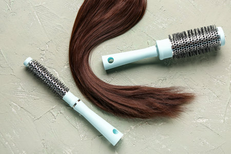 Brown hair with round brushes on grunge backgroundの写真素材