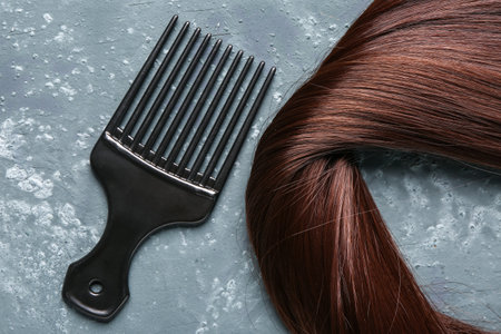 Brown hair with brush on grunge backgroundの写真素材