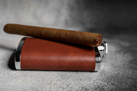 New hip flask and cigar on grunge backgroundの写真素材