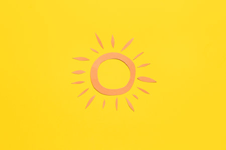 paper sun on yellow backgroundの写真素材