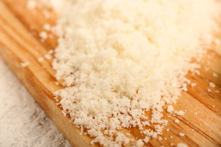 Tasty grated Parmesan cheese on table, closeupの写真素材