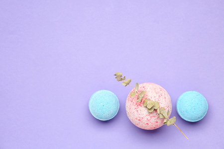 Bath bombs with eucalyptus branch on lilac backgroundの写真素材