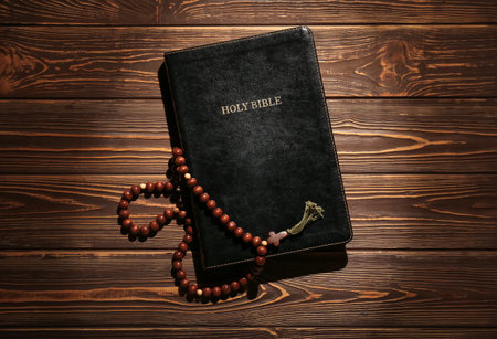 Holy Bible with prayer beads on wooden backgroundの写真素材