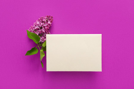 Blank card and lilac flowers on purple backgroundの写真素材