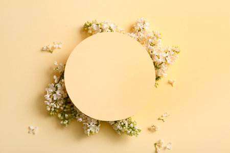 Blank card with blooming lilac flowers on beige backgroundの写真素材