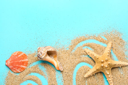 Sand with starfish and shells on blue background