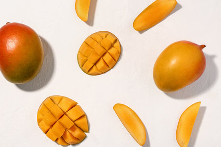 Fresh ripe mangoes on white backgroundの写真素材