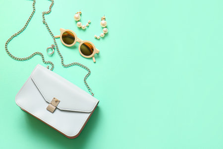 Stylish bag and accessories on turquoise backgroundの写真素材