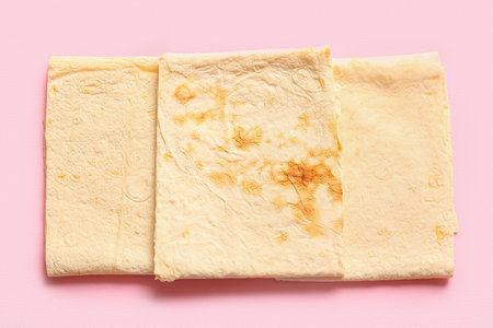 Fresh thin lavash on pink background