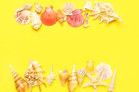 Frame made of seashells and starfishes on yellow background