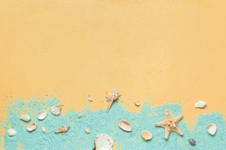 Blue sea salt with seashells and starfishes on yellow backgroundの写真素材