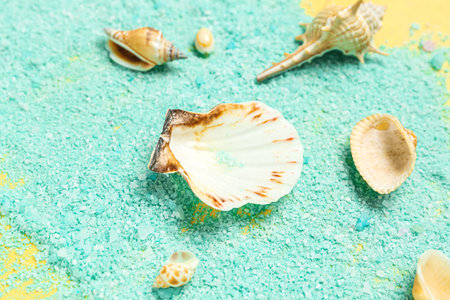Blue sea salt with seashells and starfishes on yellow background