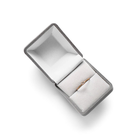 Box with engagement ring on white background
