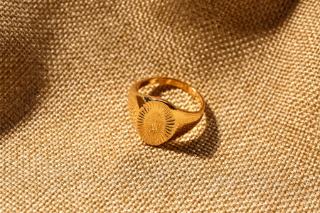 Beautiful ring on beige fabric background