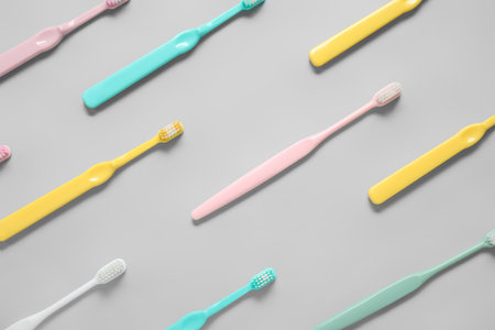 Plastic toothbrushes on gray backgroundの写真素材