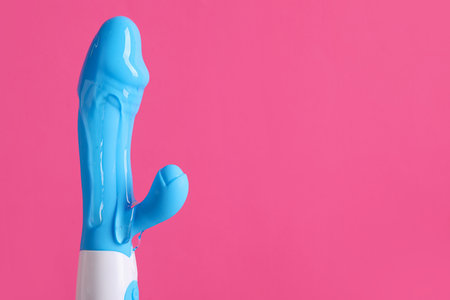 Vibrator with lubricant on pink backgroundの写真素材