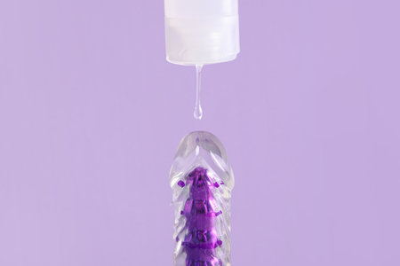 Vibrator with lubricant on lilac backgroundの写真素材