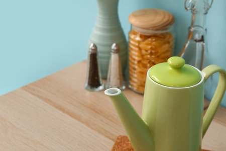 Composition with teapot and different kitchen stuff on wooden tableの写真素材