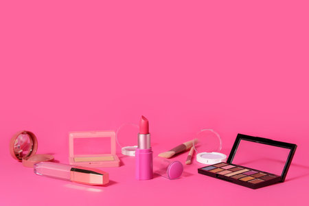 Lipstick and different cosmetics on pink backgroundの写真素材