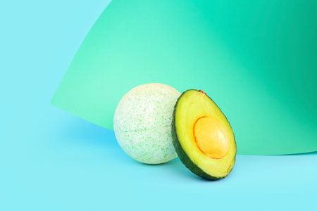 Bath bomb with avocado on paper turquoise backgroundの写真素材