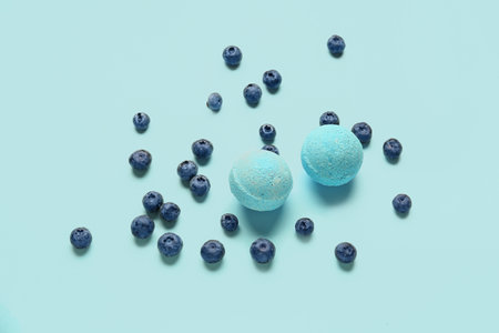 Bath bombs with blueberry on blue backgroundの写真素材