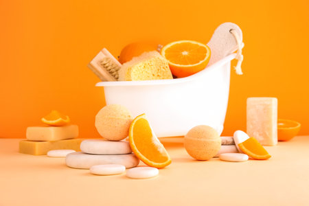 Spa composition with bath bombs and oranges on orange backgroundの写真素材