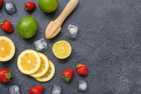 Juicer and ingredients for preparing strawberry lemonade on black backgroundの写真素材