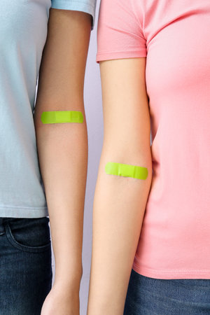 Women with applied patches on lilac background, closeup. World Blood Donor Dayの写真素材