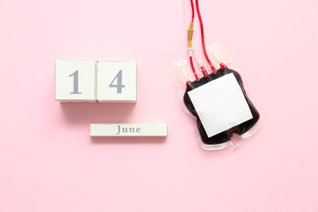 Blood pack with date 14 JUNE on pink background. World Donor Day